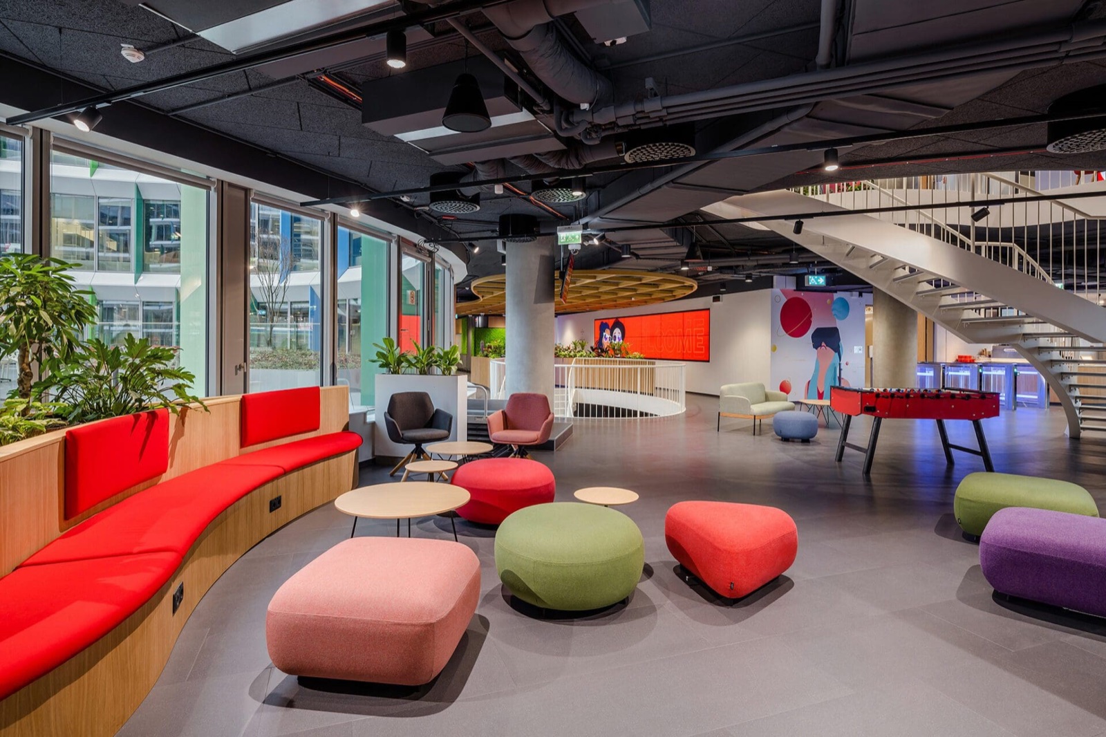 Flooring in a shared space furnished with colourful furniture