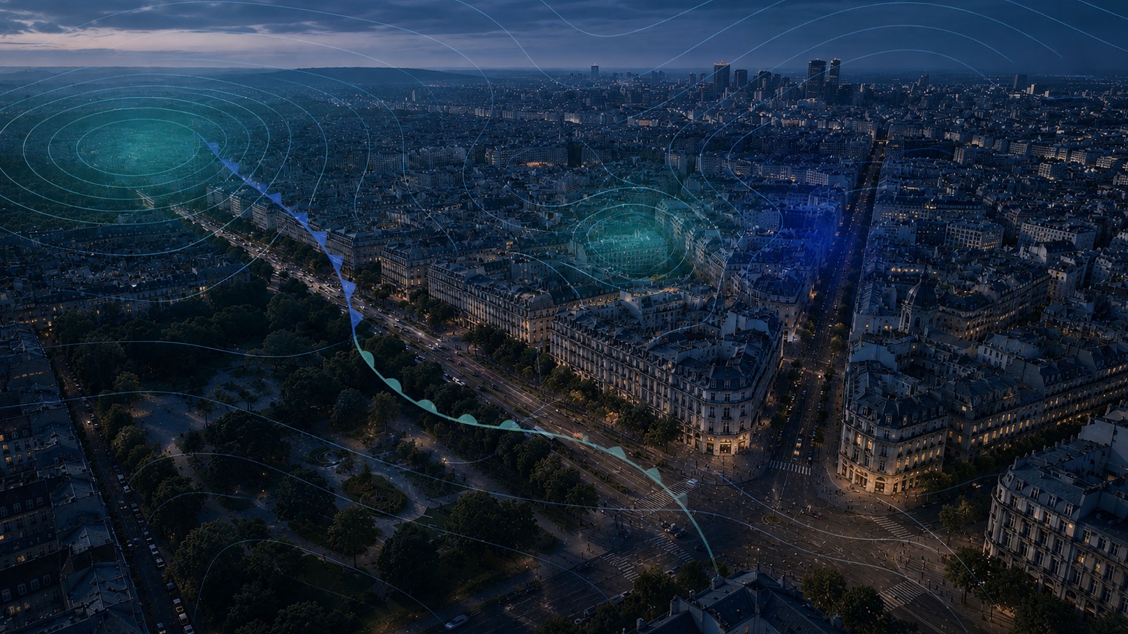 Aerial view of a city at night, with waves of light suggesting data connections above it